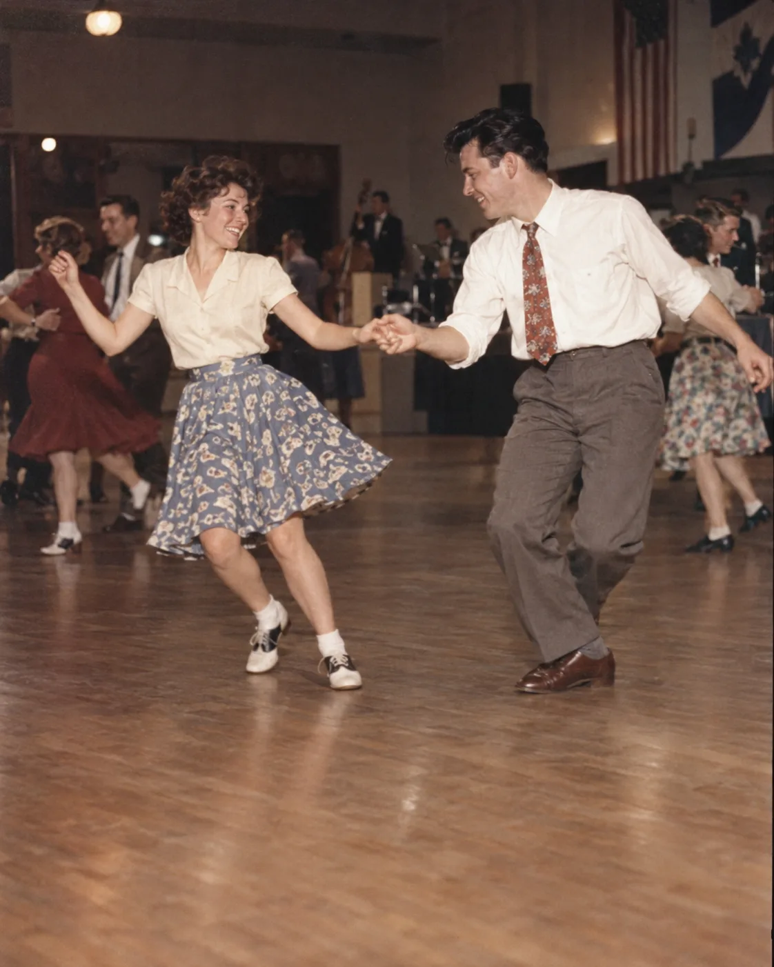 A couple dancing swing in a warmly lit hall